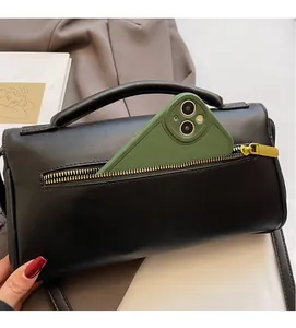 Detail view of the black square bag with a back zipper pocket and interior phone compartment