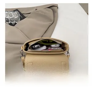 Detail view of beige lychee leather bag interior showing space for daily essentials