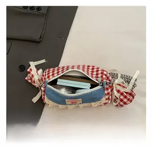 Detail view of mini candy-shaped bag interior with phone and lipstick storage