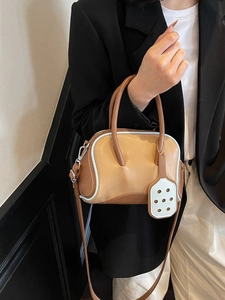 Chic brown and light blue color-block bowling handbag with detachable shoulder strap