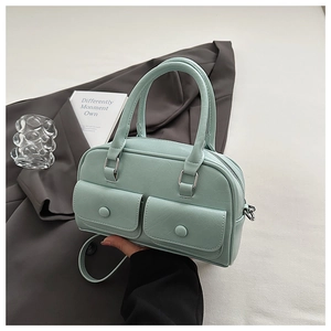 Detail of mint green PU leather bag with double front flap pockets and handle strap