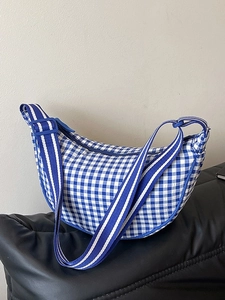 Blue and white checkered crescent crossbody bag with adjustable wide striped strap