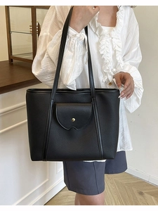 Black pebbled leather tote bag with front pocket and gold buckle for office and daily use