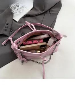 Detail view of pink tote interior with chain strap, showing spacious pockets and lining