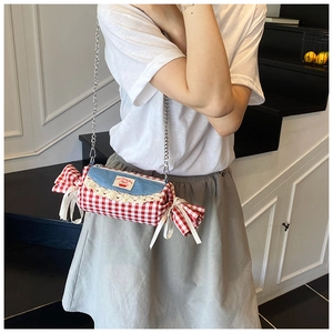 Detail of candy-shaped plaid crossbody bag with cherry embroidery and lace trim