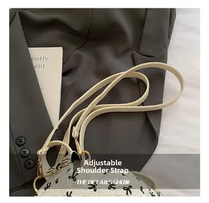 Detail of adjustable leather strap with gold hardware on a bow print backpack
