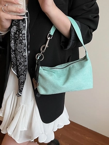 Fashionable mint green suede underarm bag with silver hardware and heart charm