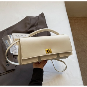 Detail of elegant beige crossbody bag with golden square clasp and leather texture