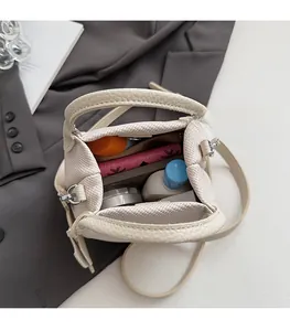 Detailed interior view of cream leather tote showing large capacity with makeup items