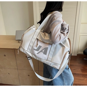 Nahaufnahme einer großen weißen Reisetasche mit khakifarbenem Besatz und JA-Logo