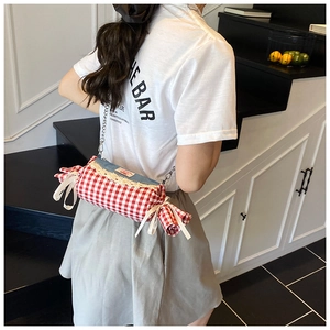 Detail of candy-shaped gingham crossbody bag with denim lace and ribbon accents