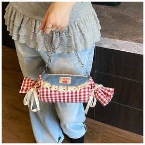Detail of candy-shaped plaid crossbody bag with sweet cherry embroidery and lace trim