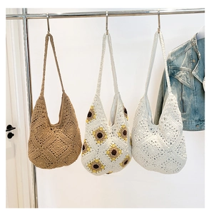 Detailed view of handmade crochet woven bags with sunflower embroidery in casual summer style