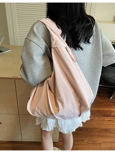 Pink large capacity hobo bag worn by model for casual style and daily commuting