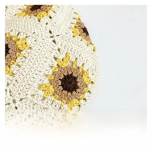 Detailed view of handmade sunflower crochet pattern on cream woven cotton summer tote bag