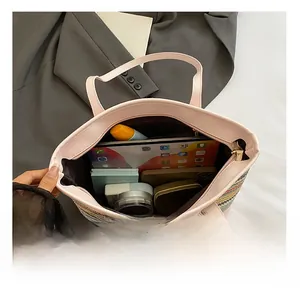 Top view of large straw tote bag showing spacious interior with compartments and zipper