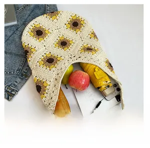 Handmade crochet tote bag showing interior capacity with phone, fruits and umbrella