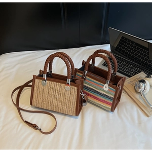 Detailed top view of natural straw and colorful striped woven handbags with brown PU handles