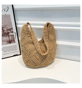 Detail of handmade beige crochet tote bag with hollow diamond pattern and fabric lining