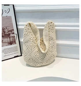 Close-up of cream hollow woven tote bag showing detailed crochet floral patterns