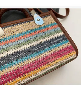Detail of chevron woven texture on colorful handbag with brown braided leather handles