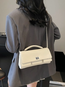 Minimalist beige rectangular crossbody bag with turn-lock and multiple pockets