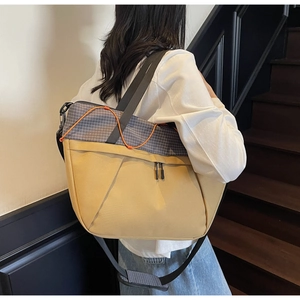 Rear view of yellow canvas tote bag with grid pattern and wide nylon straps