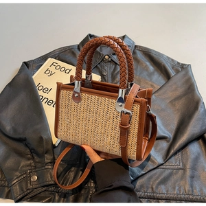 Close-up of woven texture and brown leather trim on a retro crossbody handbag