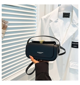 Detail of black leather crossbody bag with gold lock and Fashion & Bags text logo