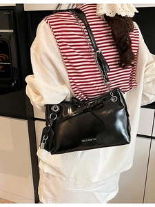 Fashionable black chain shoulder bag for women featuring a bow design and metallic lock