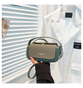 Detail of dark green leather and canvas square bag with Fashion & Bags text logo