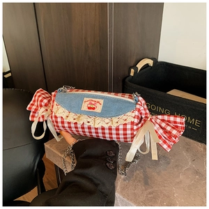 Detail of candy-shaped gingham bag featuring lace trim and Sweet Cherry patch