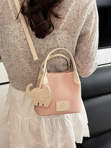 Pink checkered mini bucket bag with white lychee leather handle and elephant charm