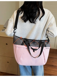 Pink and grey large capacity sports tote bag worn over the shoulder by a model