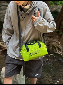Outdoor nylon crossbody bowling bag with zipper pocket shown in nature setting