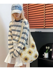 Cream handmade crochet woven tote bag with yellow sunflower pattern and wide shoulder strap