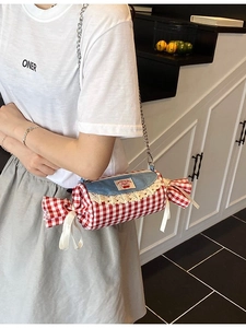 Chic red plaid shoulder bag with blue denim flap and lace trim on a metal chain strap