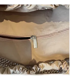 Detail of the smooth interior zipper pocket and nylon lining of a large tote bag