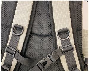 Detail of breathable mesh back padding and adjustable chest straps on nylon backpack