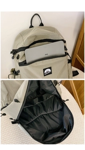 Detail of grid fabric backpack showing front tablet pocket and spacious main interior