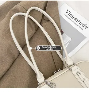 Detail of premium off-white lychee leather shoulder bag with sleek silver hardware