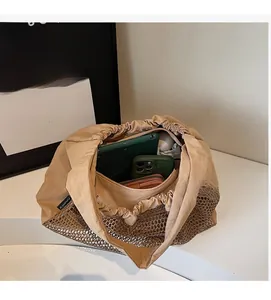 Interior view of large khaki nylon tote bag showing tablet, phone, and daily storage