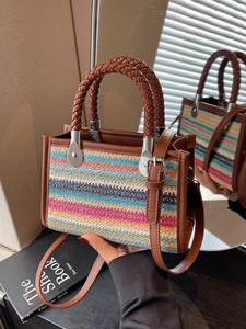 Chic multi-color woven striped tote bag with brown leather handles and shoulder strap