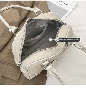 Detail view of large cream leather shoulder bag interior with silver zipper and lining