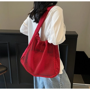 Red mesh tote bag with large capacity double-layer design shown on model shoulder