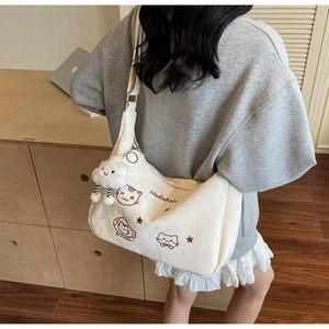 Detail of off-white large tote bag with cartoon cat print and fluffy cloud charm