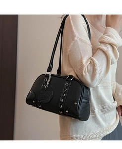 Detail of black lychee grain leather shoulder bag with silver hardware and logo tag