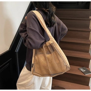 Detail of hollow nylon mesh tote bag with drawstring closure and large capacity