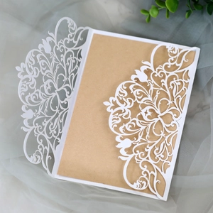 Elegant white laser-cut floral wedding invitation with brown kraft paper insert card