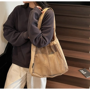Close-up of beige mesh tote bag showing canvas details and hollow nylon texture